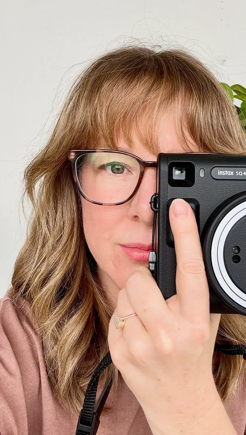 Close portrait of Laura Egliht Morton with a camera