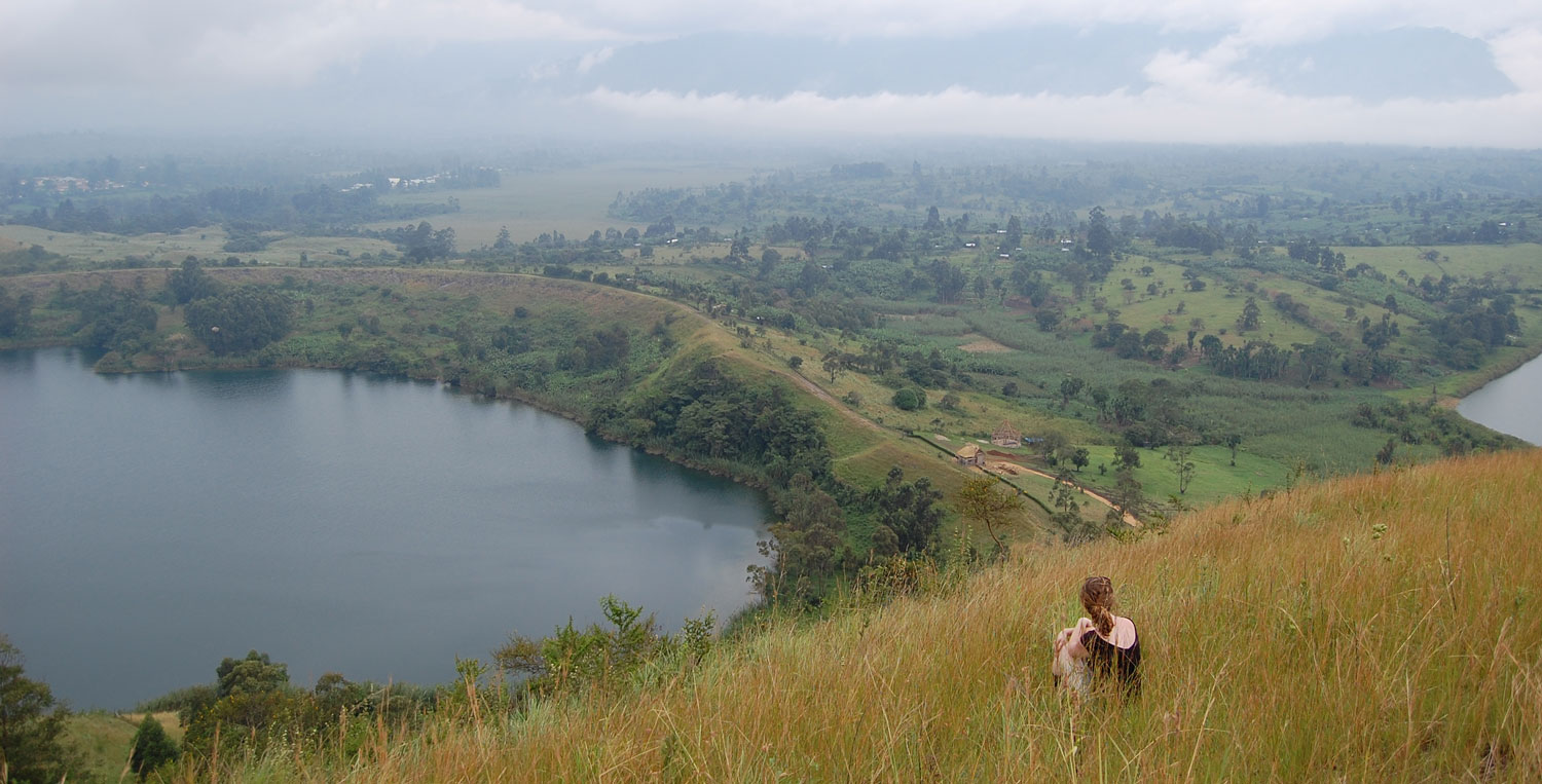 Laura Egliht Morton overlooking a green lakeside landscape